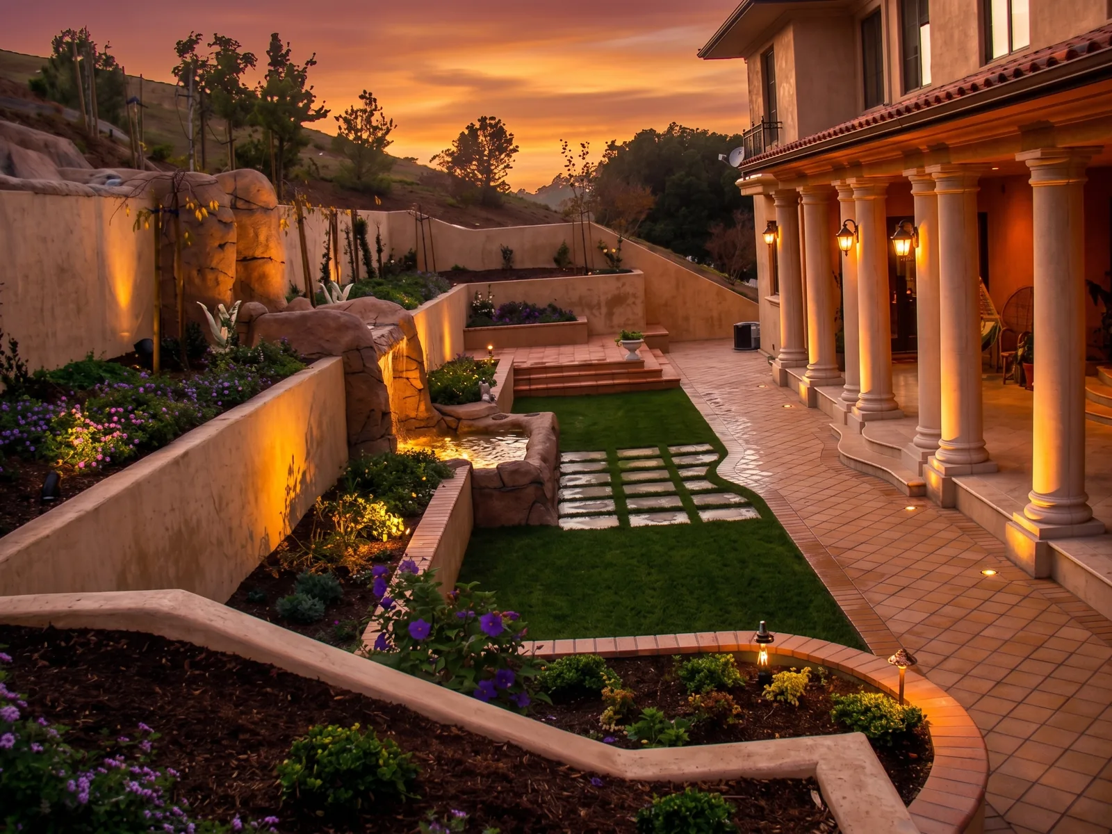 Completed terraced garden, water feature, paths, and colonnade beside the home.