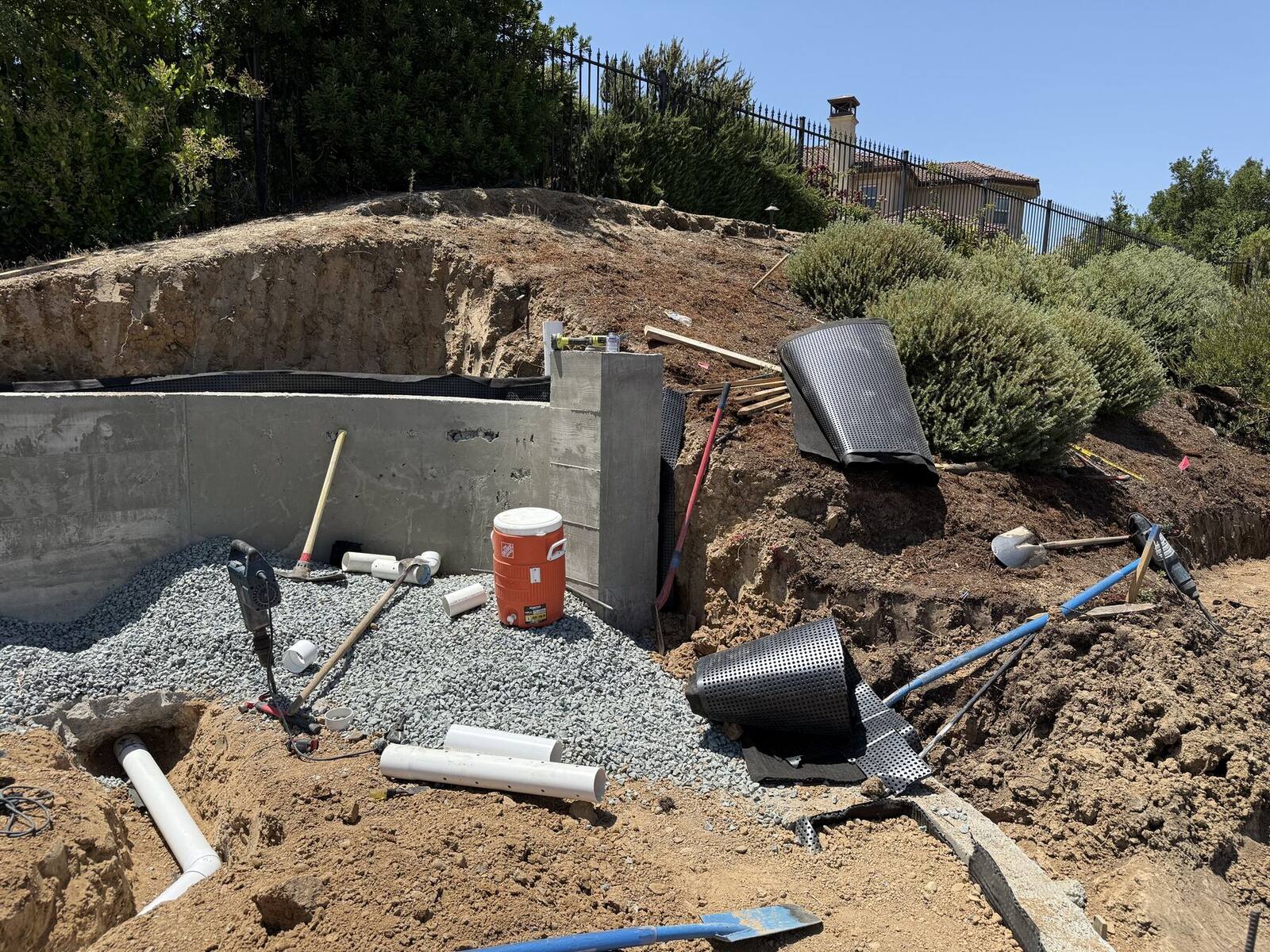 Drainage infrastructure installed behind a new retaining wall.