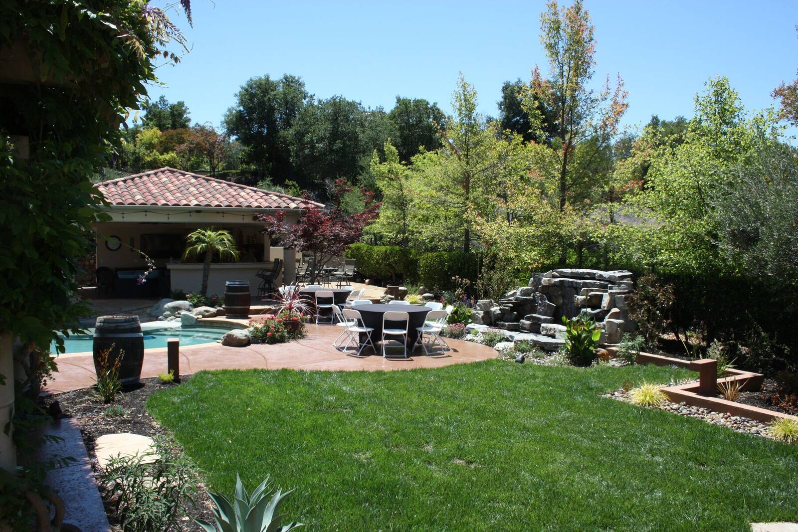 The finished lawn connecting the house, pavilion, and water feature.