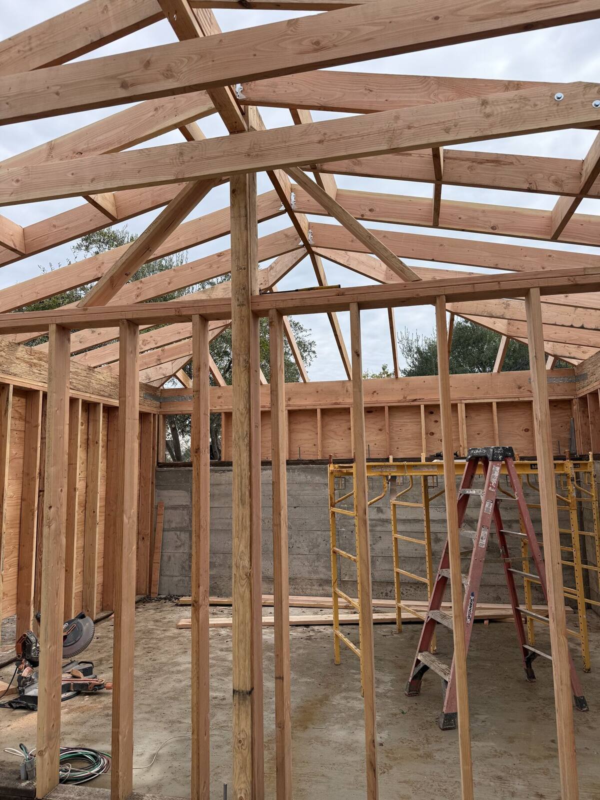 Structural framing defining the new outdoor living room.