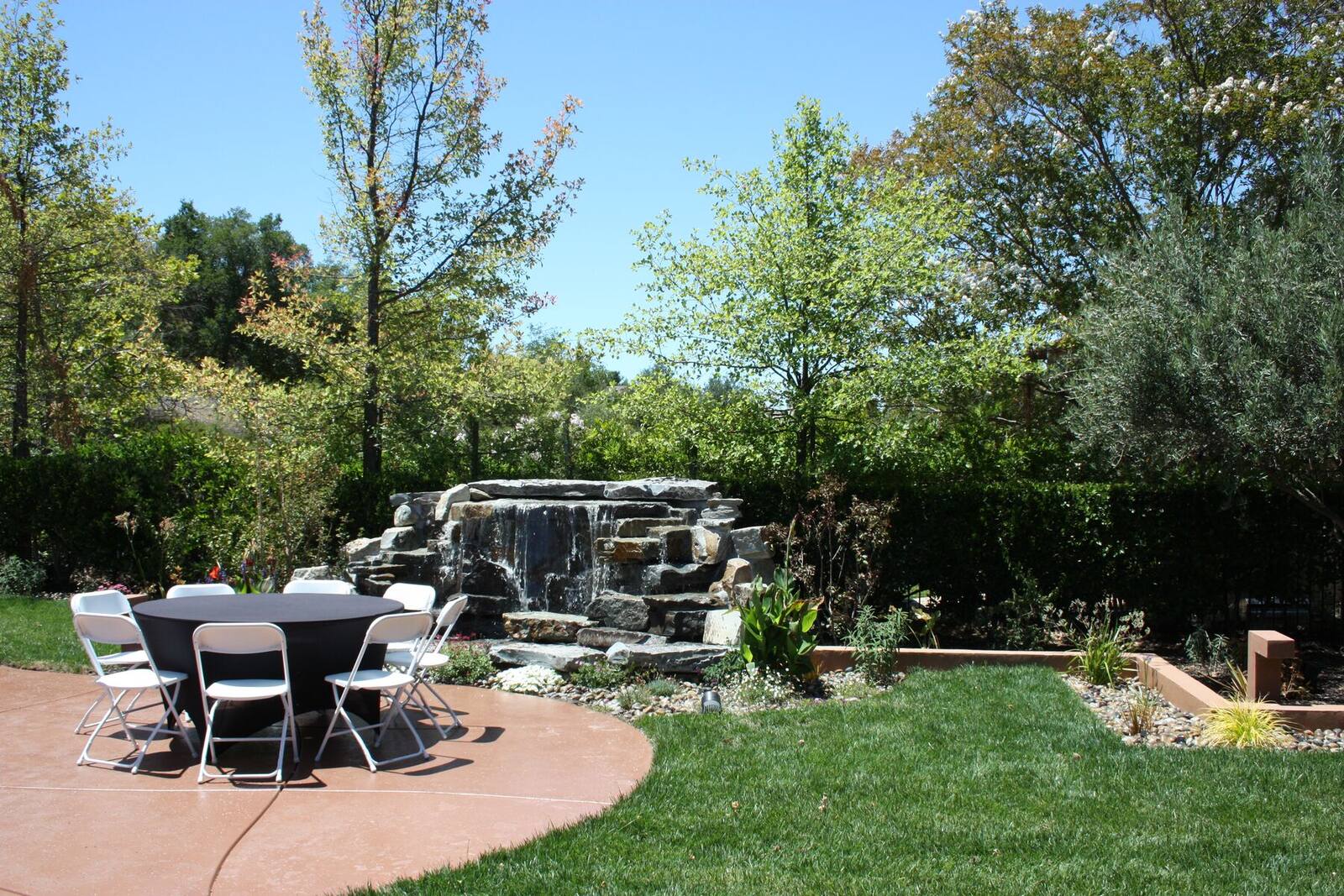 The waterfall anchoring the main outdoor gathering space.
